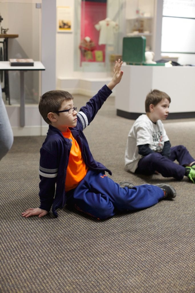 E3 2nd grade boy with hand raised