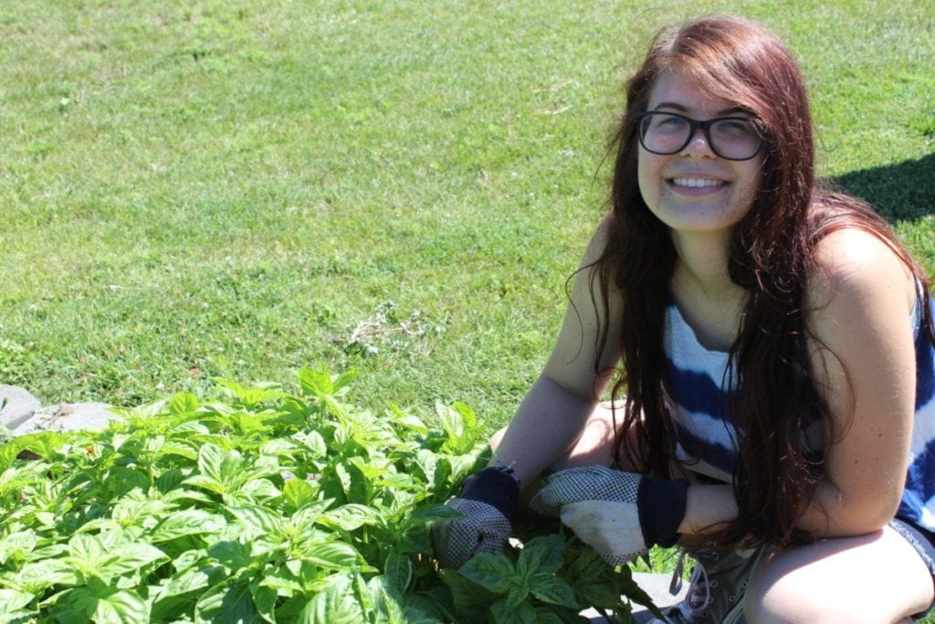 Heritage Garden Intern Marissa with our basil.