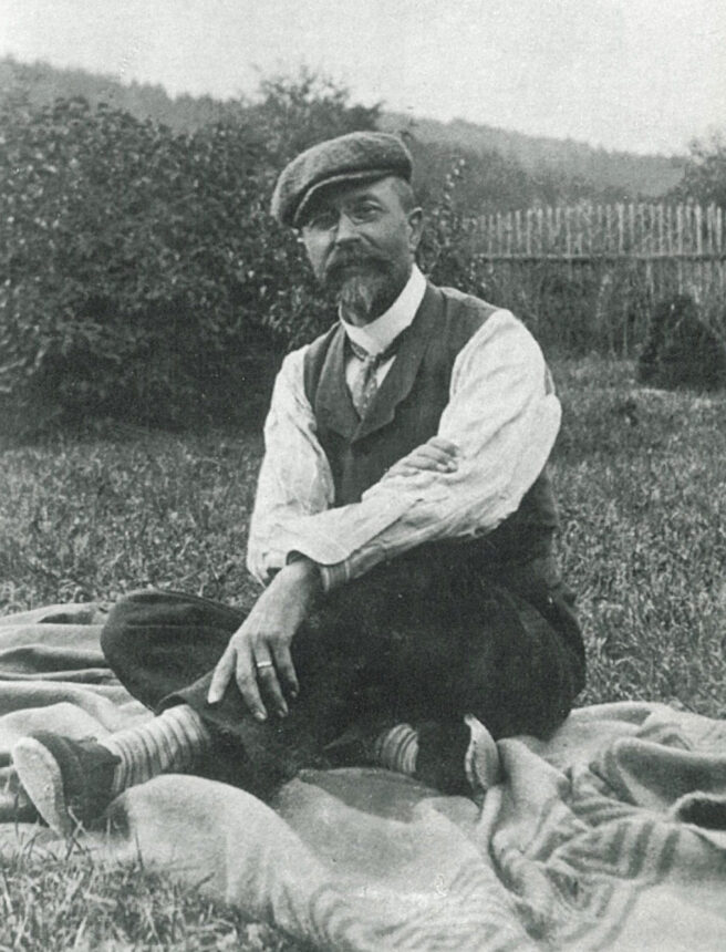 Masaryk sitting outside on a blanket